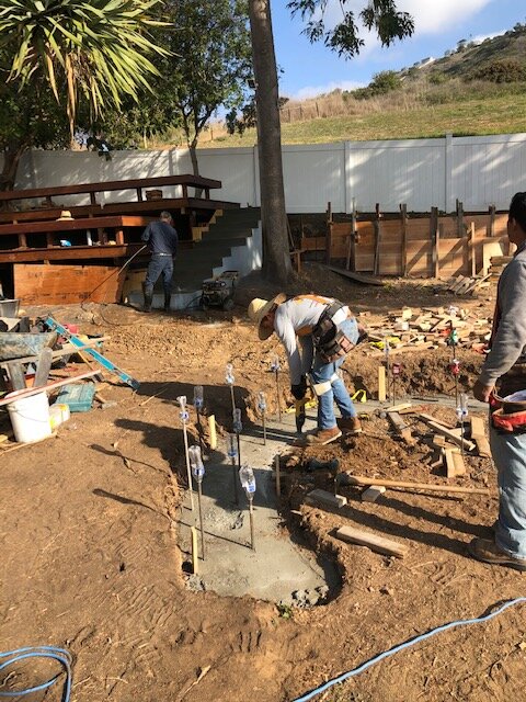 Crew setting forms and steel for built-in seating footings