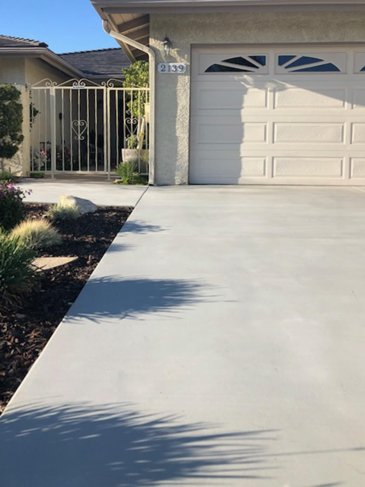 Clean gray broom-finished concrete driveway