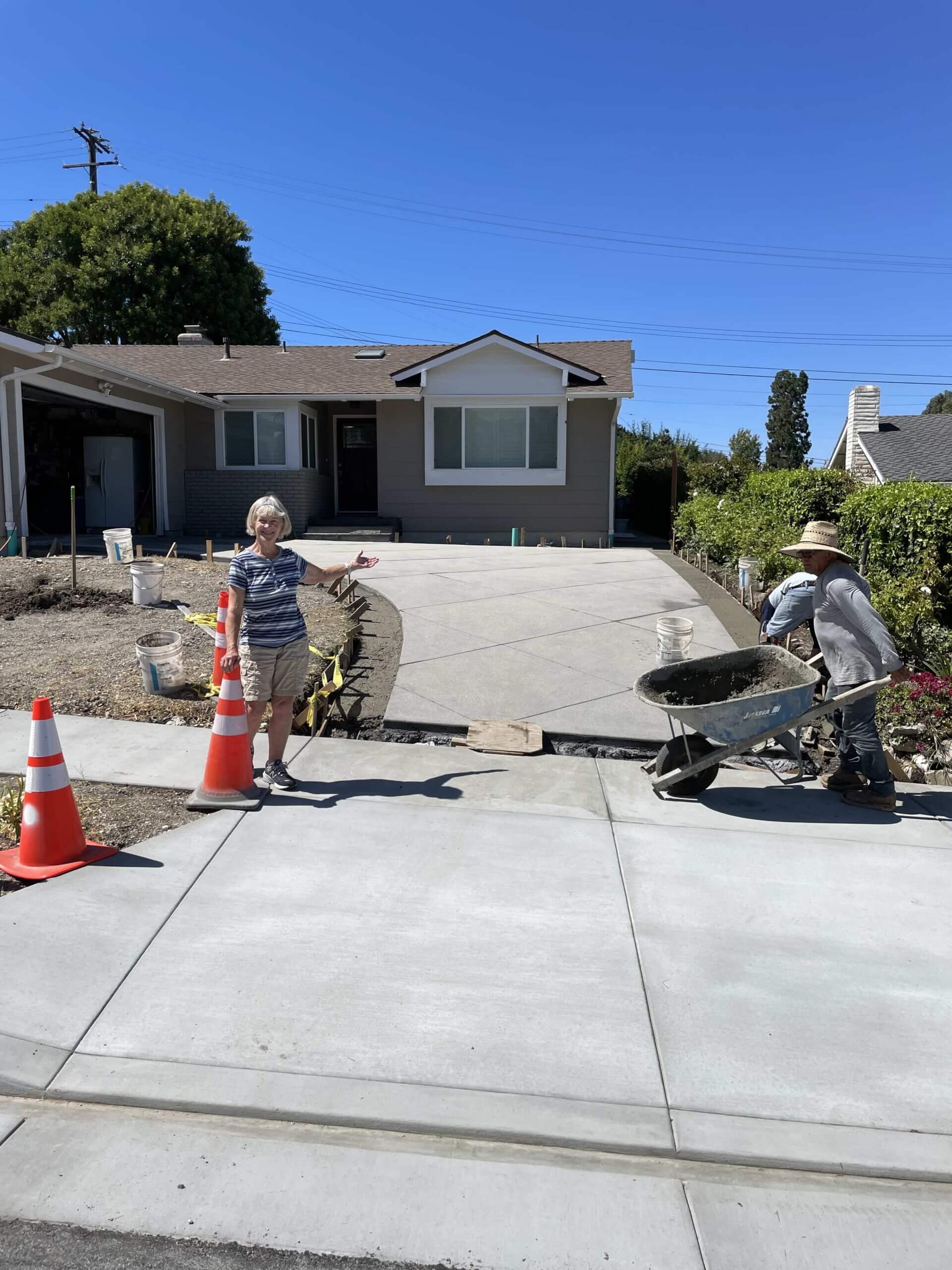 Roy's crew finishing a freshly poured concrete driveway