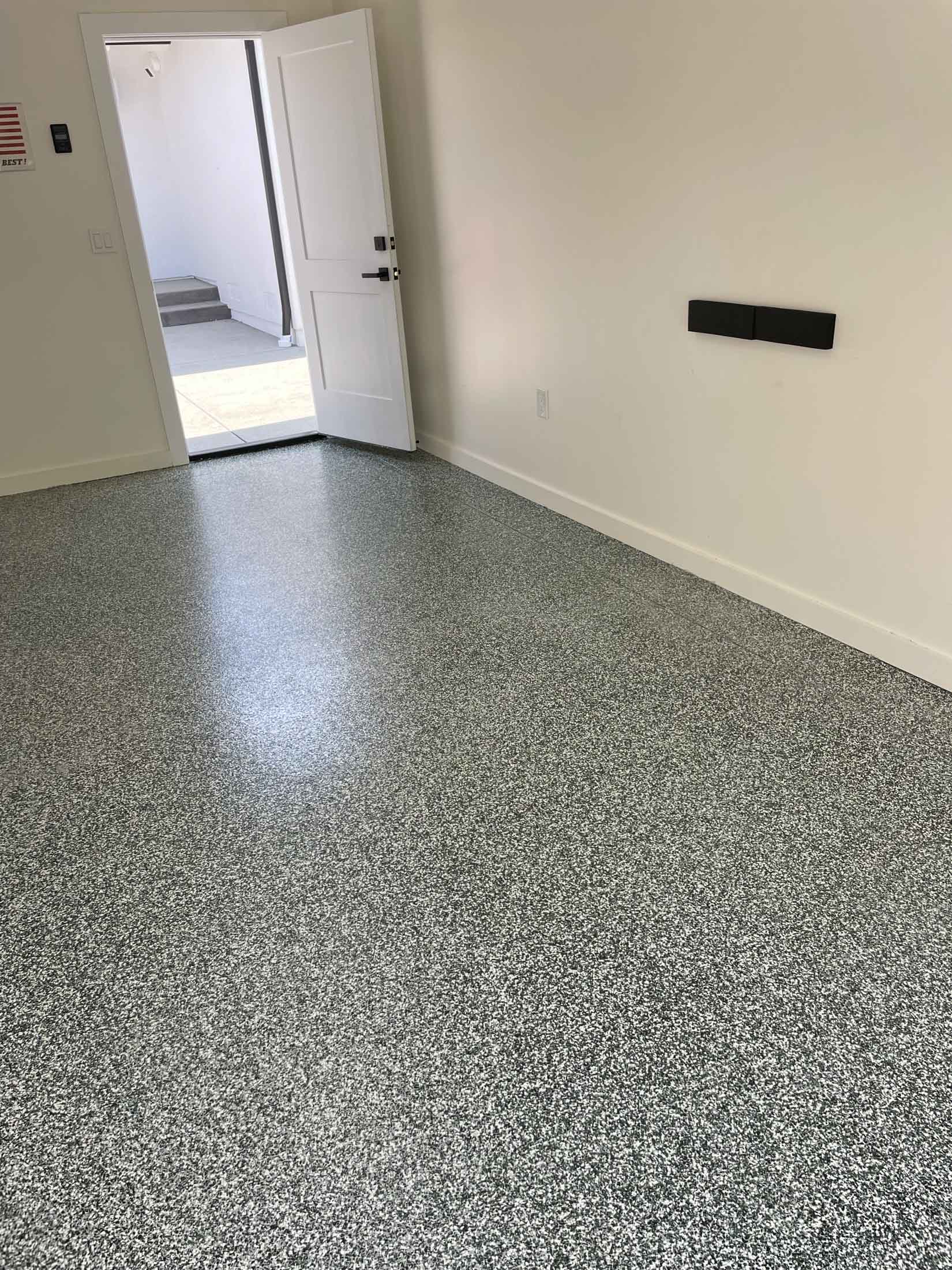 Finished garage interior with gray flake epoxy floor